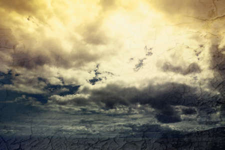 Global warming concept landscape. Dramatic cloudy sky and dry cracked earthの写真素材