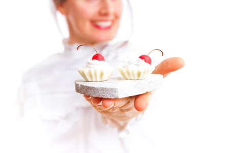 Girl offering cherry cookieの写真素材