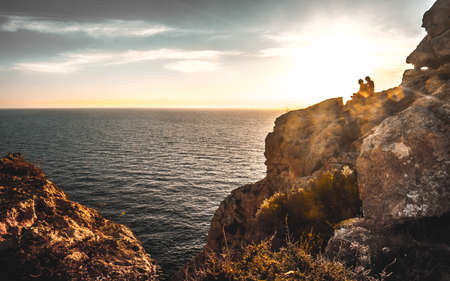 sunset among rocks with the sea in the backgroundの写真素材