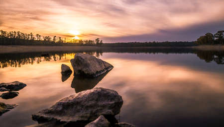 reflections in reservoir at sunsetの写真素材