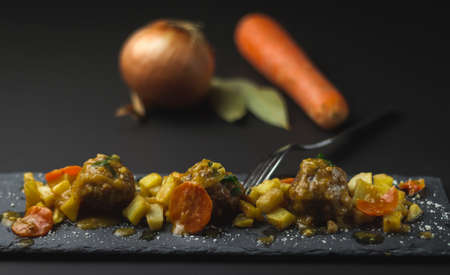 pork and beef meatballs in onion and carrot sauce with potatoes