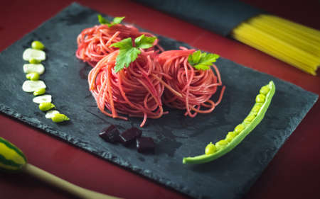 spaghetti with beetroot and green beansの写真素材