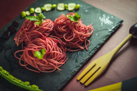 spaghetti with beetroot and green beansの写真素材