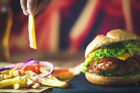 extra burger of cheese, bacon, onion and chipsの写真素材
