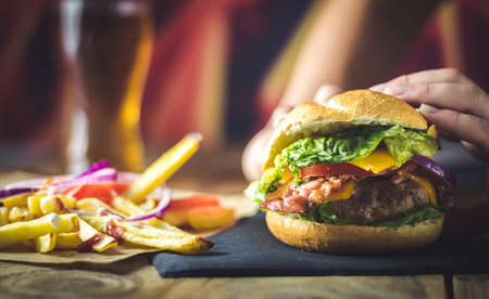 extra burger of cheese, bacon, onion and chipsの写真素材