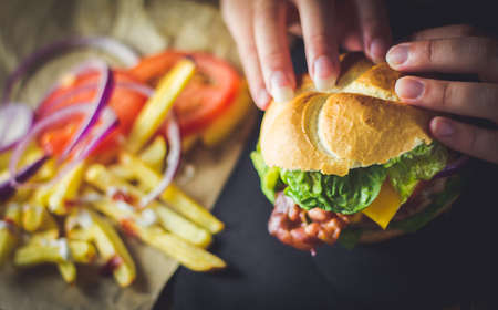 extra burger of cheese, bacon, onion and chipsの写真素材