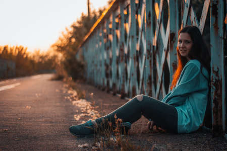 session on old iron bridge at sunset with bicycle and skateboardsの写真素材
