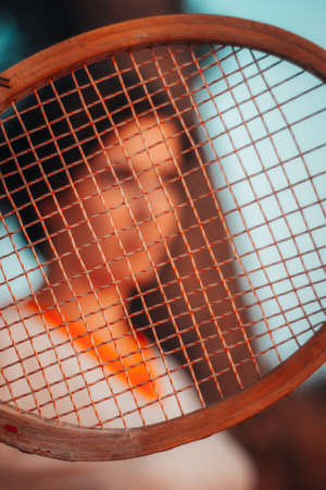 portrait with vintage clothes and wooden racketの写真素材