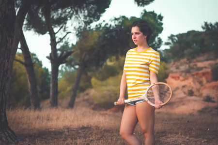 portrait with vintage clothes and wooden racketの写真素材