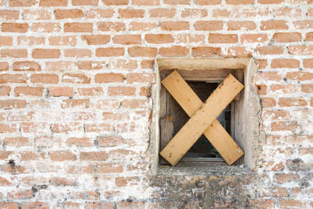 An old closed window of an abandoned houseの写真素材