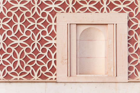 Empty niche of an old house with a red wallの写真素材