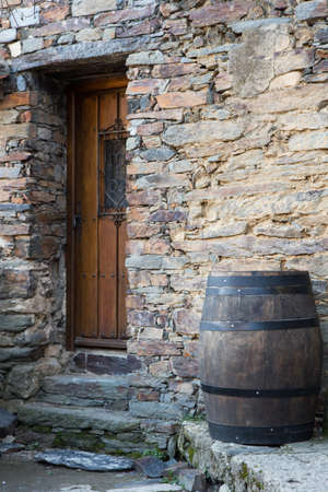 An old barrel close to a door