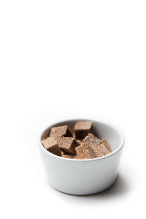 Brown sugar cubes isolated in a white backgroundの写真素材
