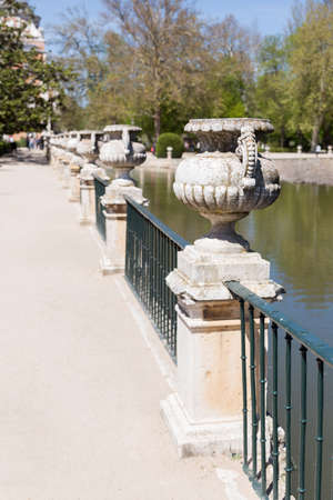 Stone jars over a railing near a riverの写真素材