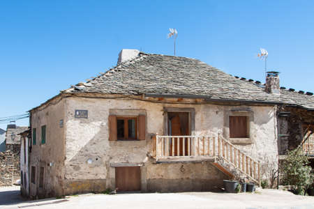 Old house in the village of Valverde de los Arroyos, one of the Black Villages Guadalajara (Spain), with the OcejÃ³n Peak in the backgroundのeditorial素材