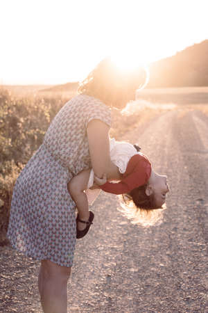 Portrait of happy mother and daughter in the countryの写真素材