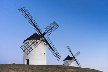 Typical windmill in with the moon at the background in Castilla la Mancha, Spainの写真素材