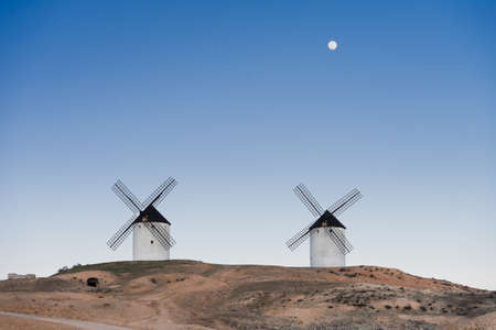 Typical windmill in with the moon at the background in Castilla la Mancha, Spainの写真素材