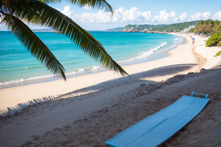 Tropical beach with blue lounger on the sand.の素材