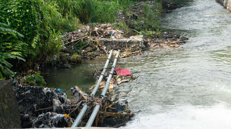 River bank with plastic garbage. It cannot be recycled and pollutes the environment