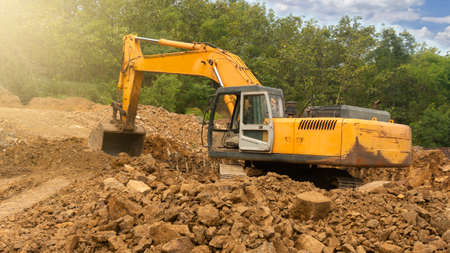 Excavators are dredging mining rocks to be used as raw materials for building buildings and houses...