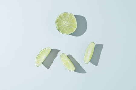 Minimal concept of raw limes on the grey background. Flat lay layout.の写真素材