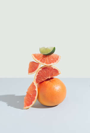 Creative idea made of grapefruit and lime slices. Minimal natural composition on pastel background.の写真素材