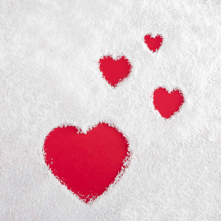 Dark red hearts in the white powder. Valentine's days symbol. Minimal flat lay.の写真素材
