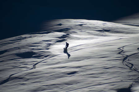 Late afternoon snowboarder on powderの写真素材
