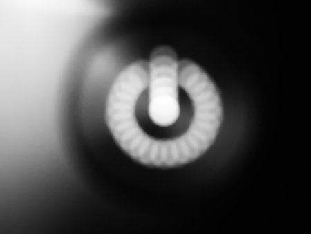 bokeh - blurred power sign light in power button - black and white / monochrome using for background