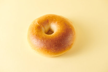 Bagel on a yellow background. Close-up view.の写真素材