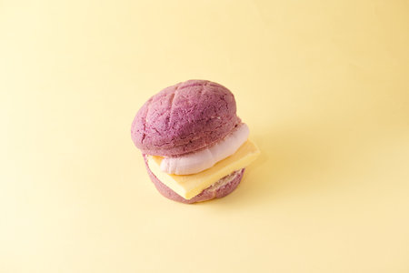 Colorful macaroons on yellow background. Minimal food concept.の写真素材