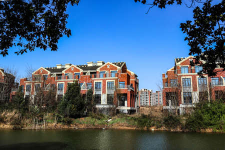 The houses along the river are all built and ready for sale by construction developersの写真素材