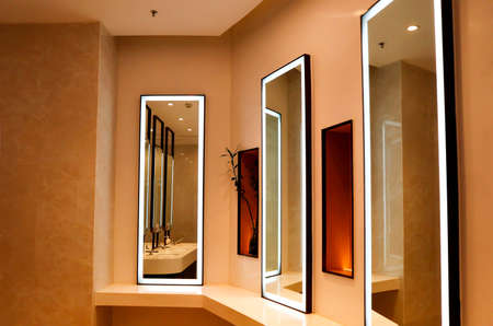 Modern interior of a bathroom with a mirror and a reflection in the mirrorの写真素材