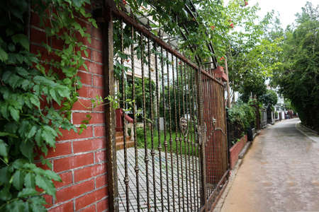 This is a beautiful Chinese community. The fence of the villa was overgrown with green plants