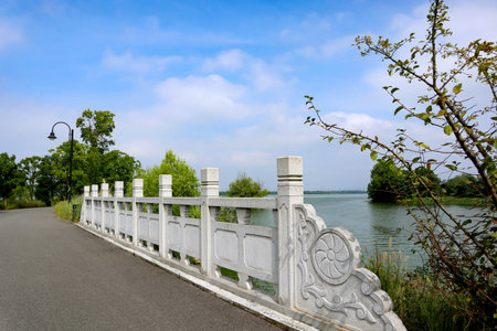 This is a beautiful view of a park in China with a strong stone bridgeの写真素材