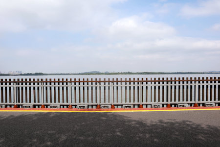 beautiful view of a park in China with a beautiful wooden bridge over the lakeの写真素材
