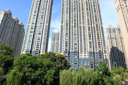 Under the blue sky, these modern skyscrapers are apartments and offices in a Chinese cityの写真素材