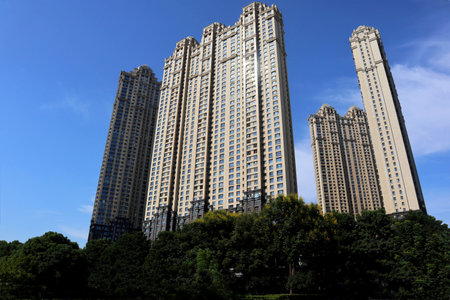 Under the blue sky, these modern skyscrapers are apartments and offices in a Chinese cityの写真素材