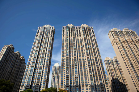 Under the blue sky, these modern skyscrapers are apartments and offices in a Chinese cityの写真素材