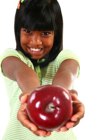 Beautiful happy 10 year old Indian girl sharing apple.の写真素材