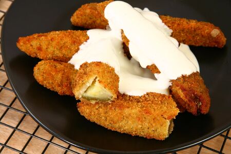 Plate of fried pickles and ranch dressing.の写真素材