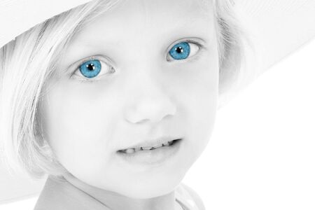 Black and White of young girl with  bright blue eyes in a hat.  Shot in studio over white with the Canon 20D.の写真素材