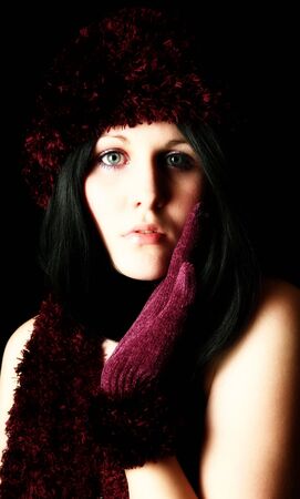 Close up beautiful young woman in knit hat and gloves.