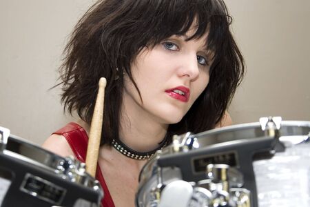 Beautiful young woman with drums.の写真素材