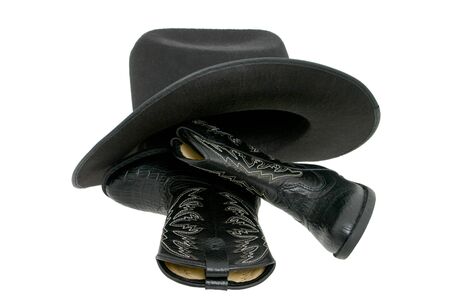 Set of toddler boots and a black fetl hat isolated on white.の写真素材