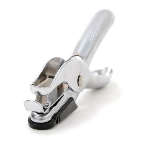 Metallic silver hole puncher on a black plastic base shot on white background.の写真素材