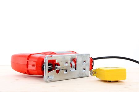 Jigsaw And Measuring Tape On Table 