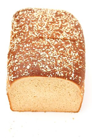 Fresh sliced honey wheat bread sprinkled with rolled oats.  