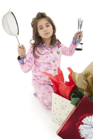 Girl child opening bad christmas gift over white with disapointed sad expression.の写真素材
